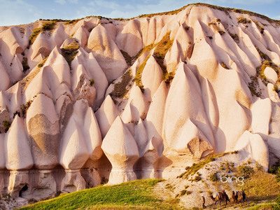 Eroded rock formations and camels in Uchisar, Cappadocia, Turkey (© Marc Dozier/Corbis)
